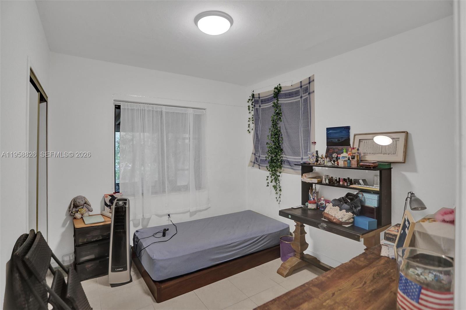 3255 Southwest 60th Avenue Miami, FL 33155 - Photo 28 of 42 a living room with furniture and a flat screen tv
