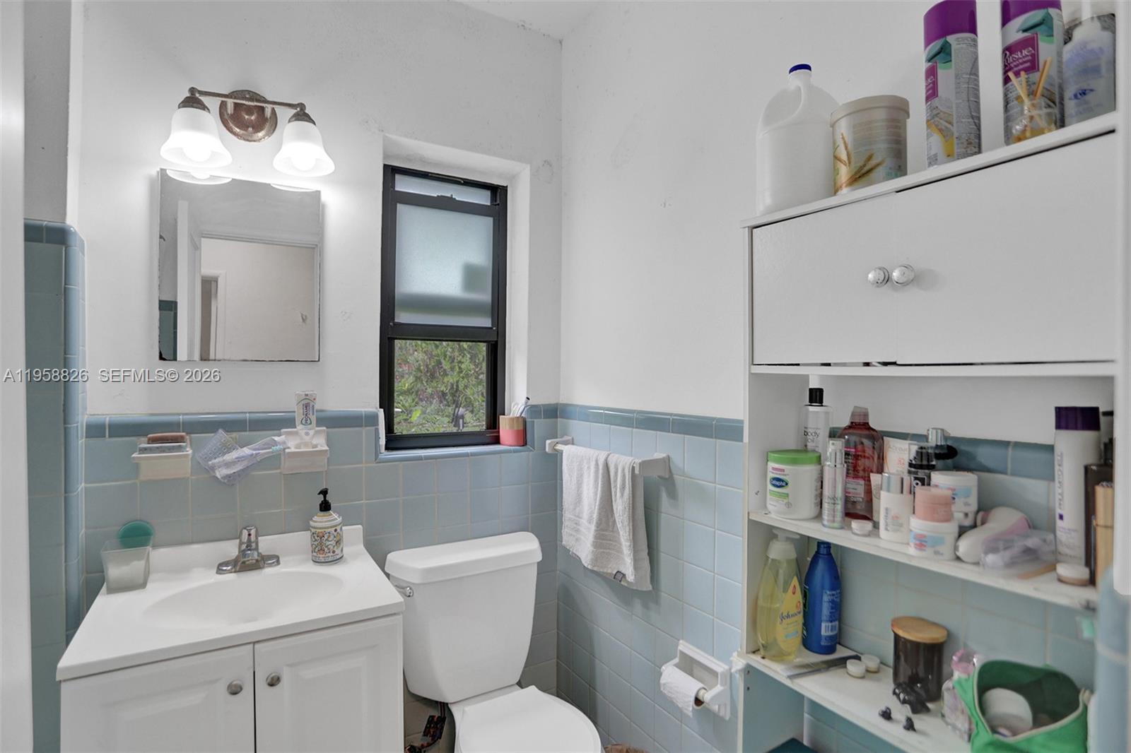 3255 Southwest 60th Avenue Miami, FL 33155 - Photo 29 of 42 a bathroom with a sink mirror and toilet