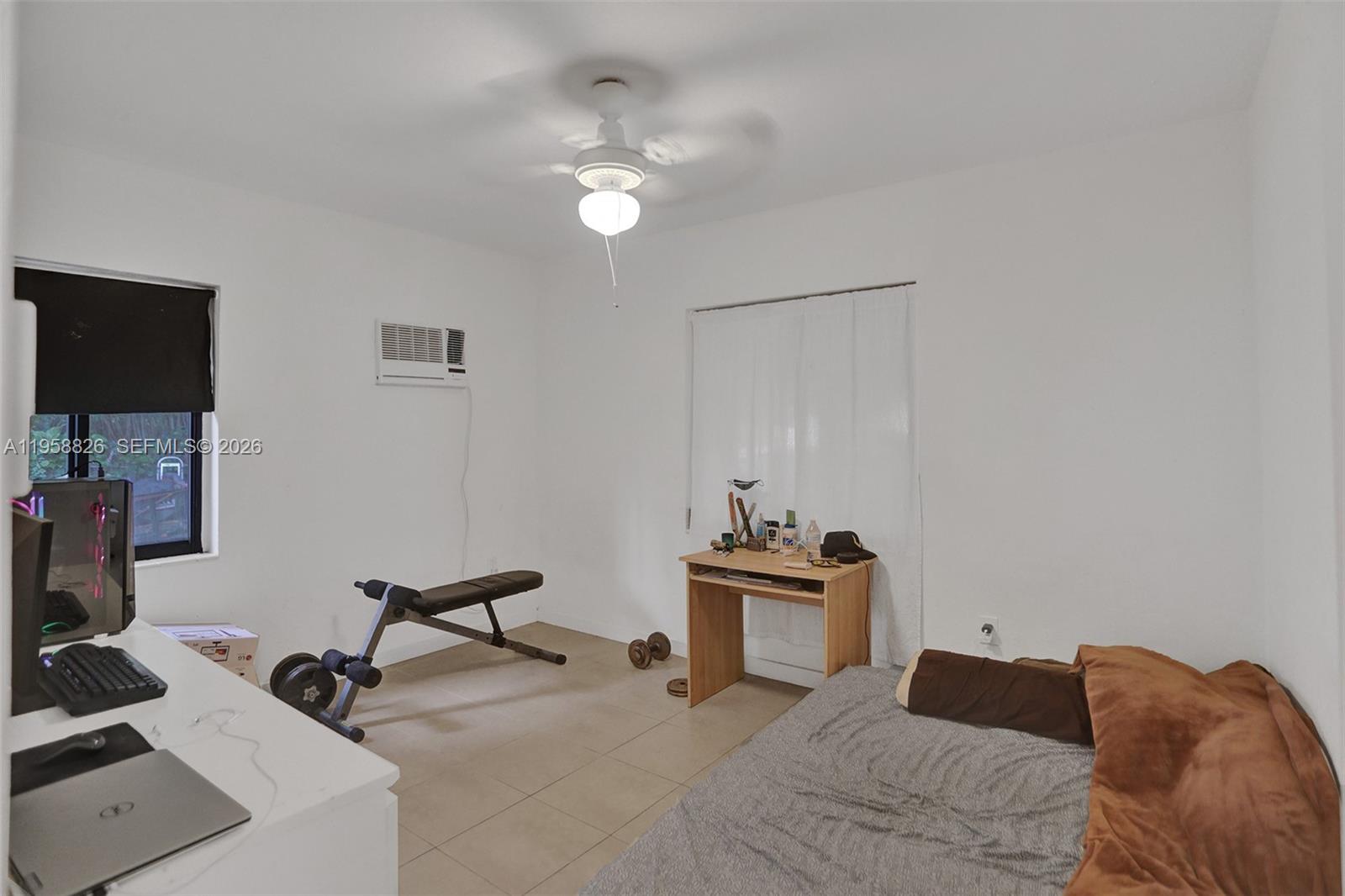 3255 Southwest 60th Avenue Miami, FL 33155 - Photo 31 of 42 a bedroom with a bed and a chandelier