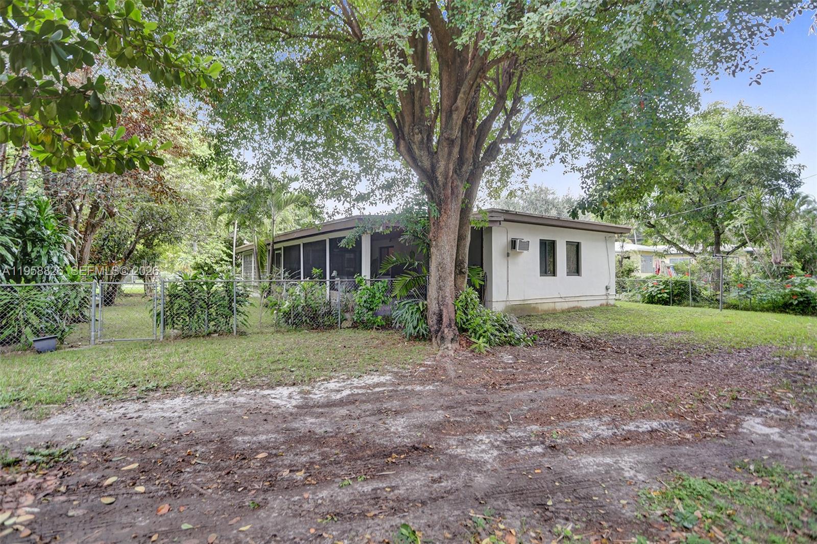 3255 Southwest 60th Avenue Miami, FL 33155 - Photo 38 of 42 a white house that has a tree in front of it