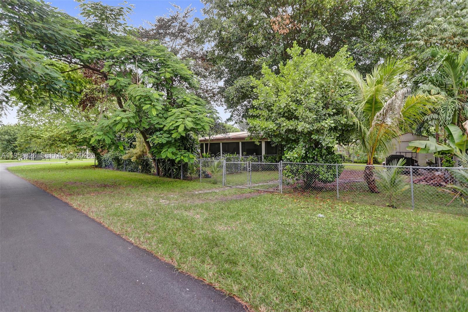 3255 Southwest 60th Avenue Miami, FL 33155 - Photo 6 of 42 a front view of a house with garden