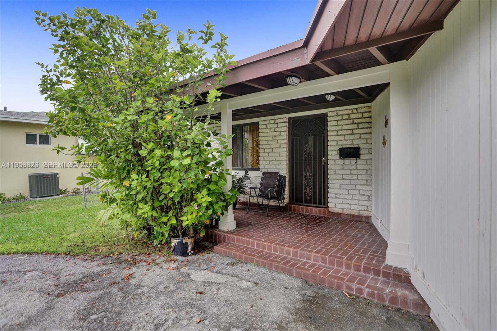 3255 Southwest 60th Avenue Miami, FL 33155 - Photo 8 of 42 a view of a house with a small yard and floor to ceiling window