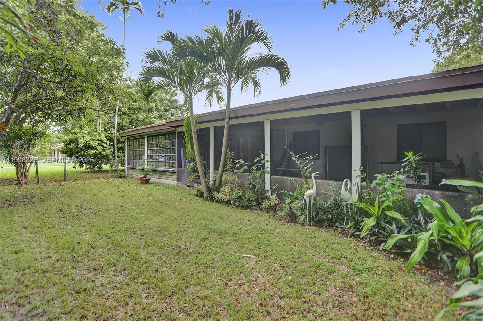 3255 Southwest 60th Avenue Miami, FL 33155 - Photo 10 of 42 a view of a house with backyard and a tree