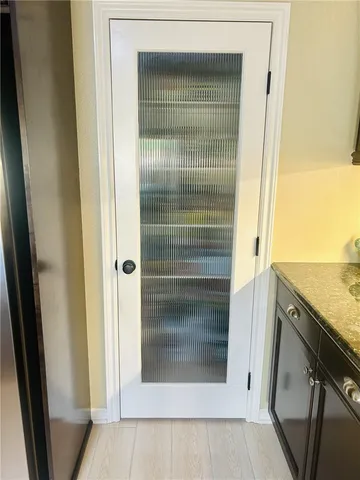 a kitchen with stainless steel appliances kitchen island granite countertop a table chairs sink and refrigerator