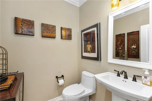 a dining room with wooden floor a chandelier a wooden table and chairs