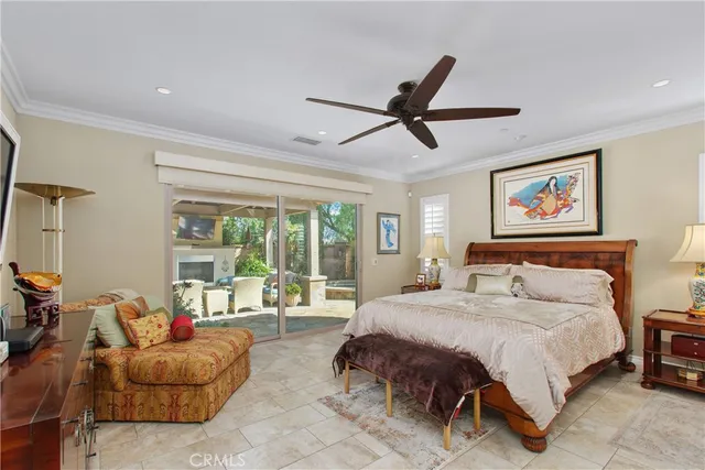 a spacious bedroom with a bed and a chandelier