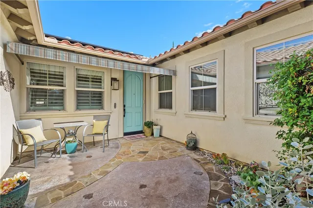 a front view of a house with outdoor seating