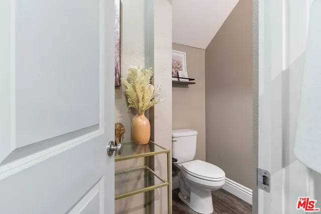a white toilet sitting next to a bathroom sink