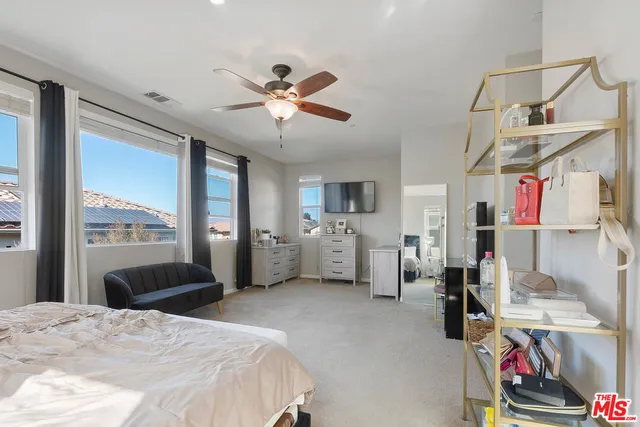 a bedroom with furniture and a chandelier