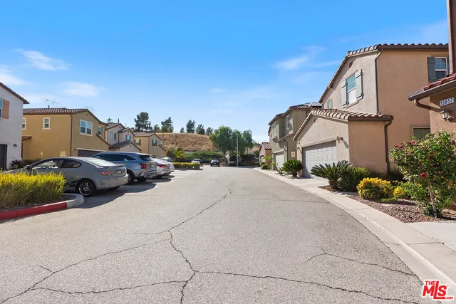 a view of multiple houses with a street