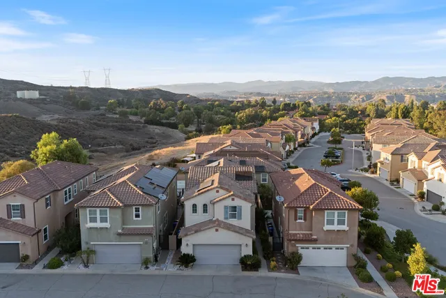 an aerial view of residential houses and city street