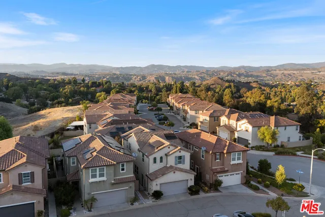 an aerial view of residential houses with city view