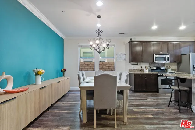 a dining room with furniture and a chandelier