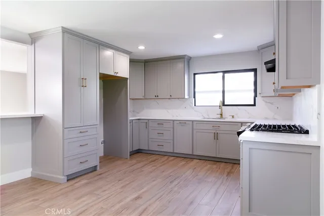 a kitchen with white cabinets and white appliances