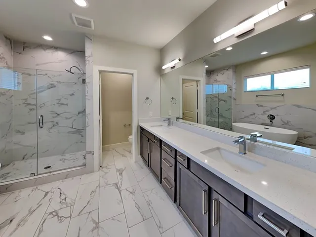 a bathroom with a sink a toilet and mirror