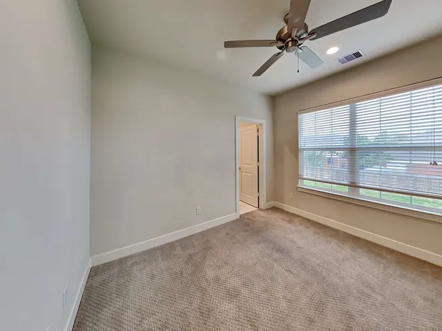 a bathroom with double vanity and a mirror