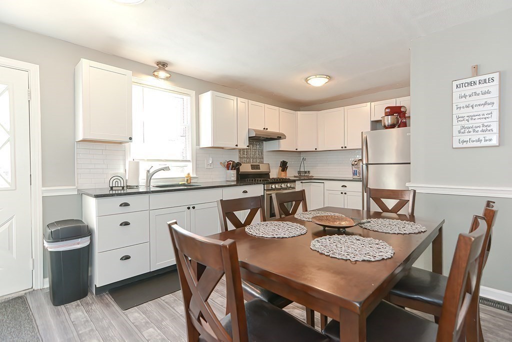 43 Cliff Road Bourne, MA 02532 - Photo 6 of 21 a kitchen with stainless steel appliances granite countertop a dining table chairs and sink