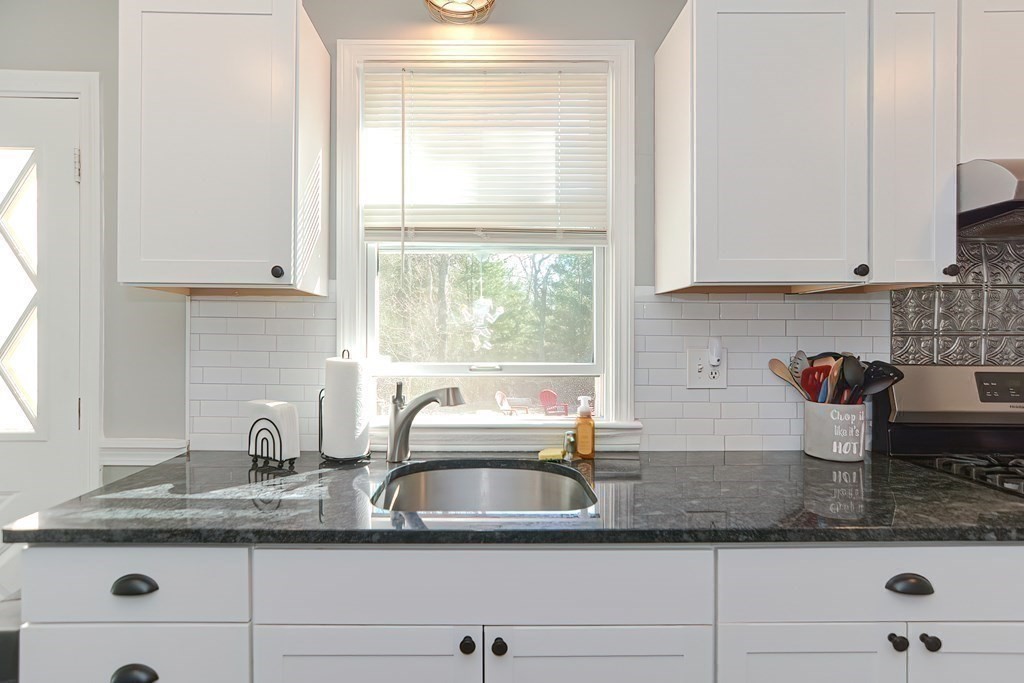 43 Cliff Road Bourne, MA 02532 - Photo 8 of 21 a kitchen with granite countertop a sink window and cabinets