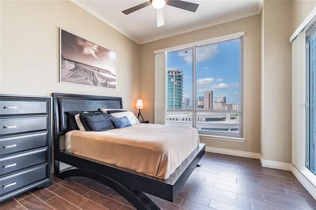 a bedroom with a large bed and a large window