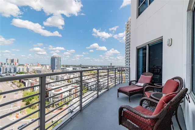 a balcony with chairs and outdoor views