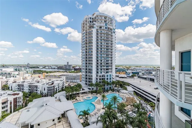 a view of a patio with a table and chairs under an umbrella