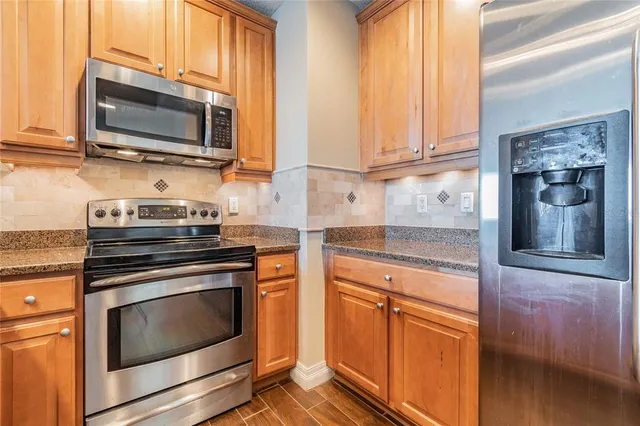 a kitchen with granite countertop a sink and a counter top space