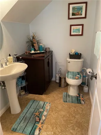 a bathroom with a sink toilet and a mirror