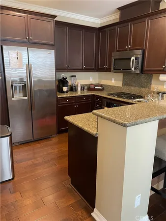 a kitchen with a refrigerator sink and cabinets