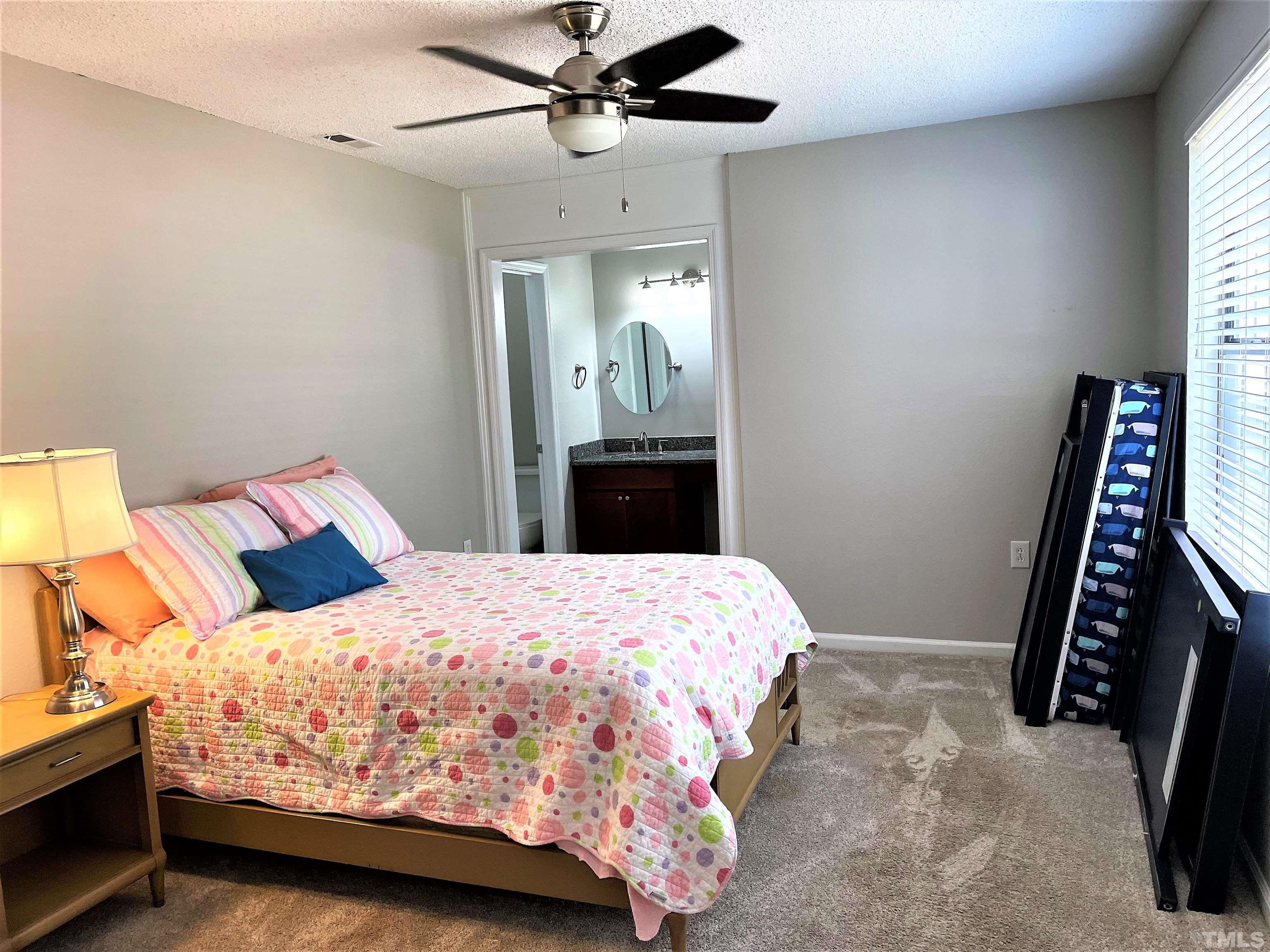 2416 Condor Court Raleigh, NC 27615 - Photo 11 of 28 a bedroom with a bed and a mirror