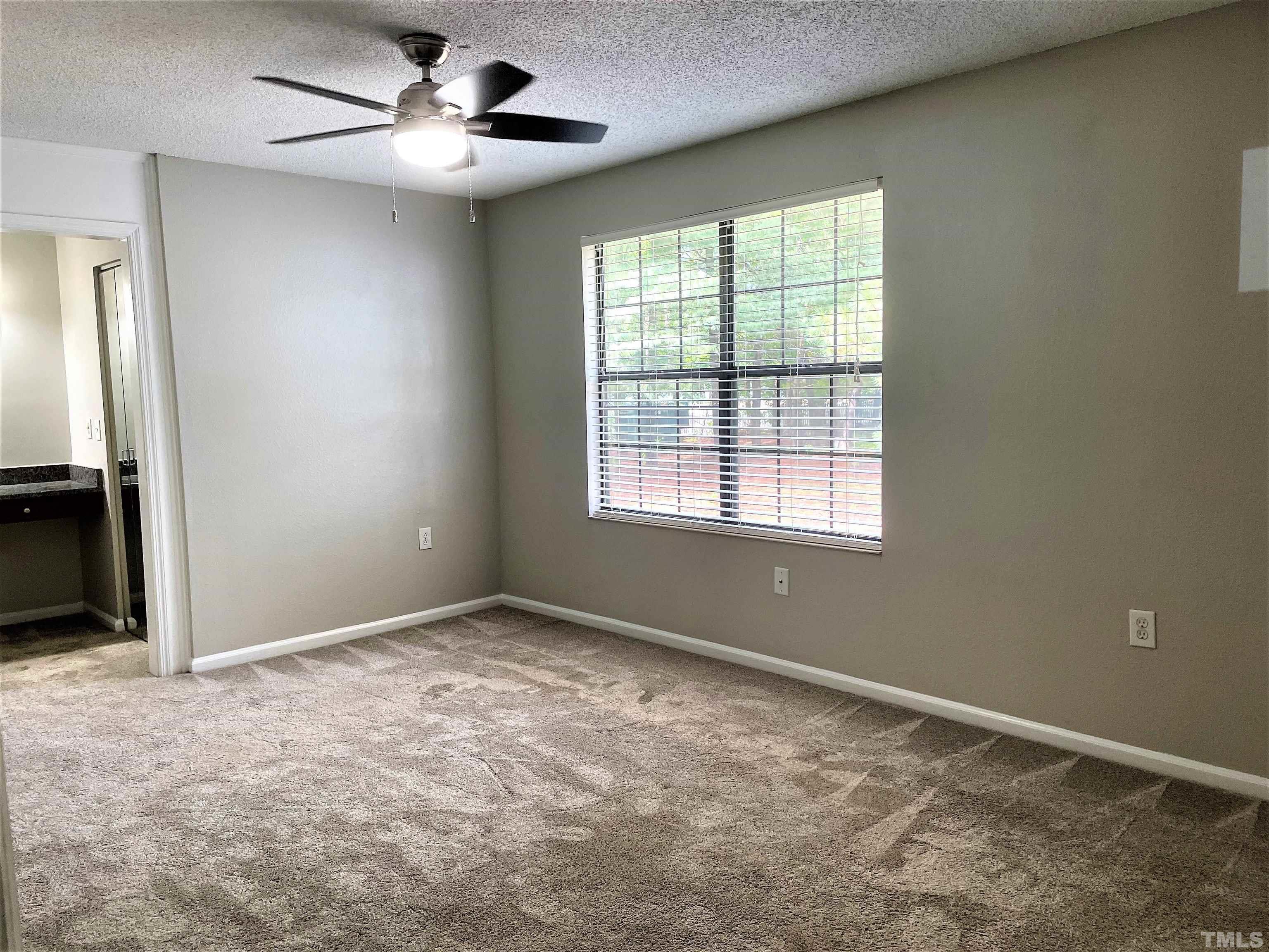 2416 Condor Court Raleigh, NC 27615 - Photo 24 of 28 an empty room with windows and fan