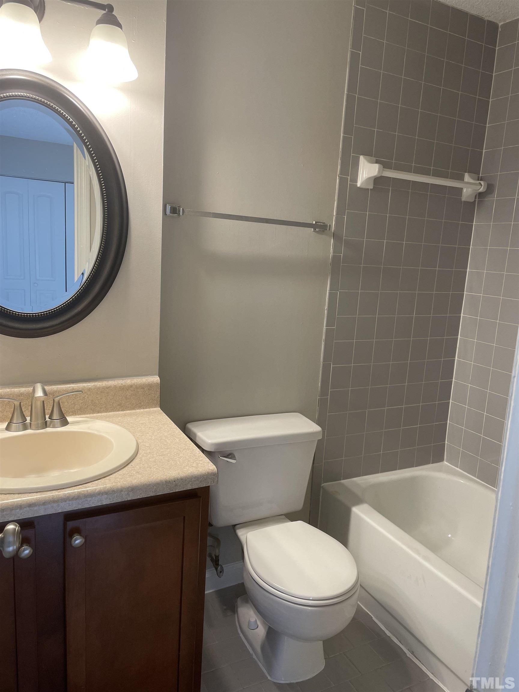 2416 Condor Court Raleigh, NC 27615 - Photo 26 of 28 a bathroom with a sink a toilet and shower