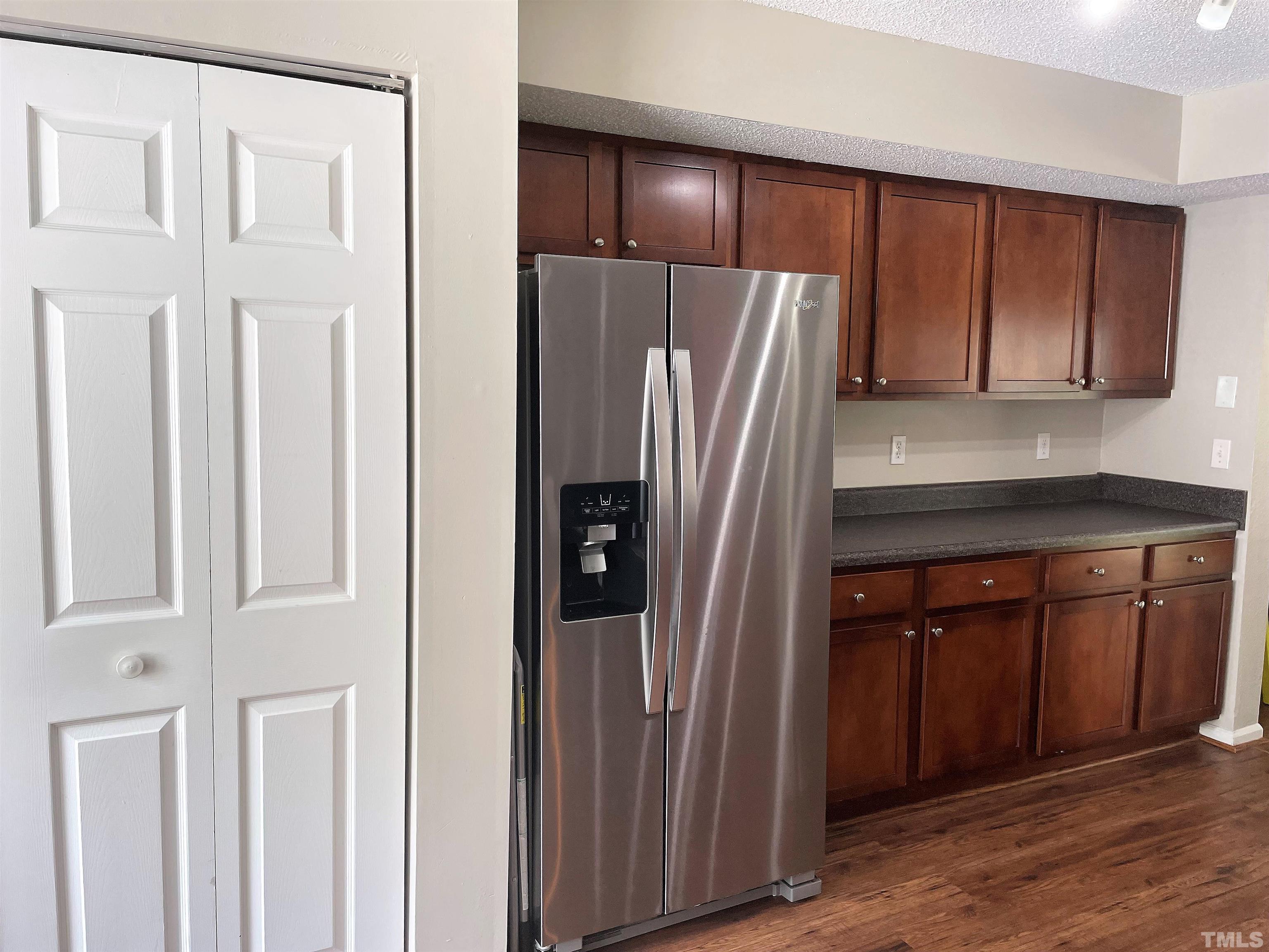 2416 Condor Court Raleigh, NC 27615 - Photo 6 of 28 a kitchen with stainless steel appliances granite countertop a refrigerator and a sink