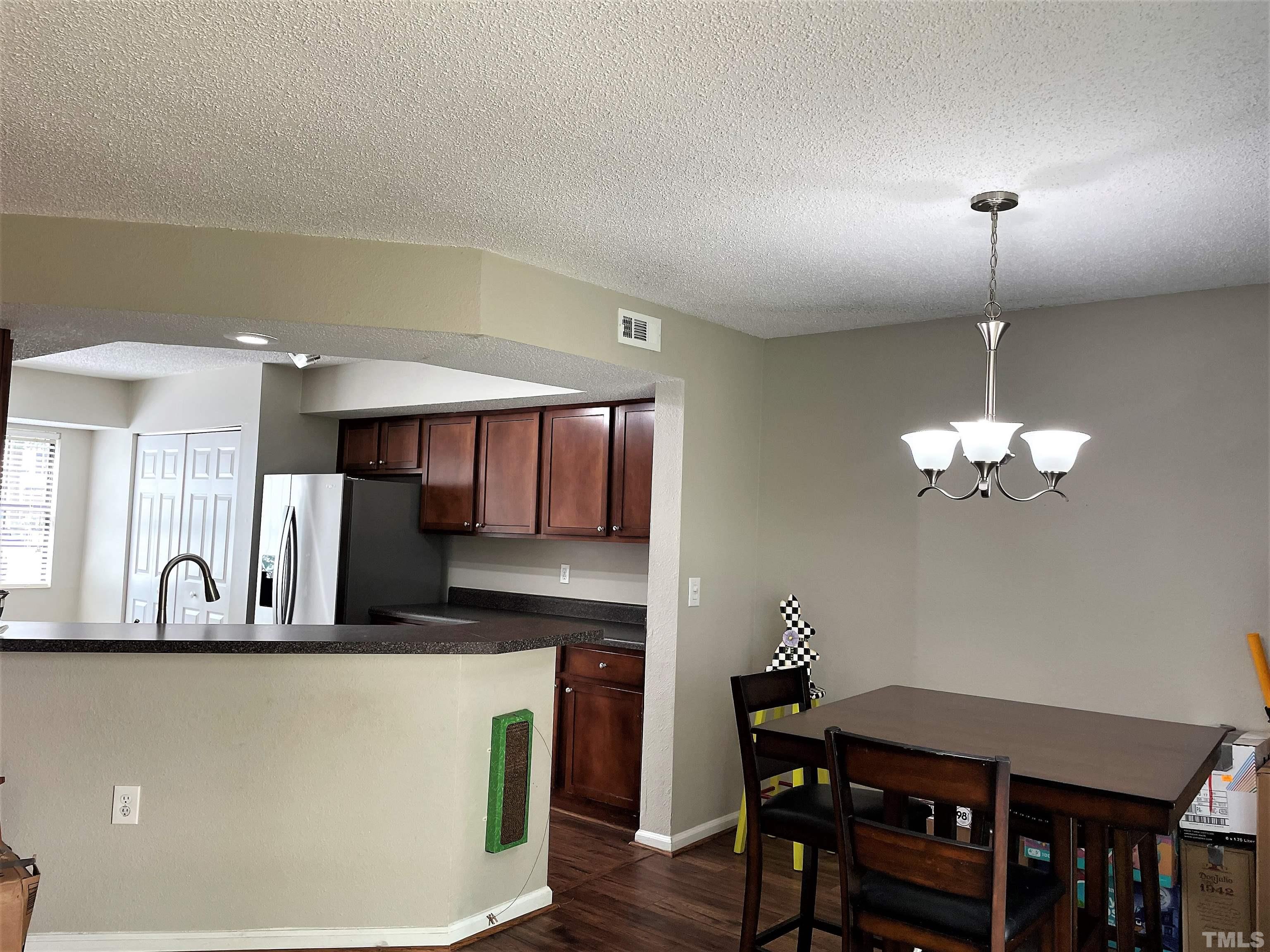 2416 Condor Court Raleigh, NC 27615 - Photo 7 of 28 a view of a dining room with furniture and wooden floor