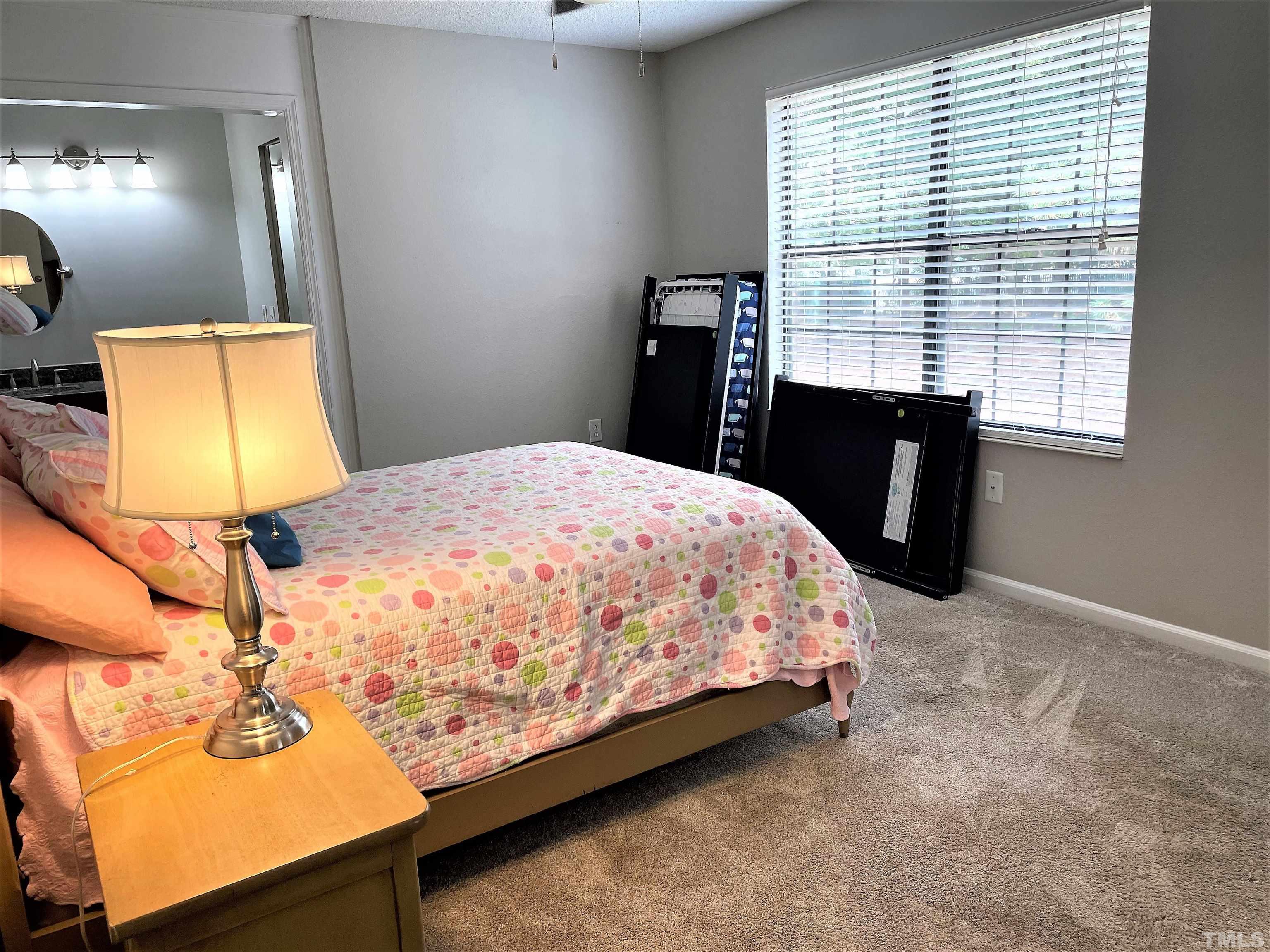 2416 Condor Court Raleigh, NC 27615 - Photo 10 of 28 a bedroom with a bed and a window