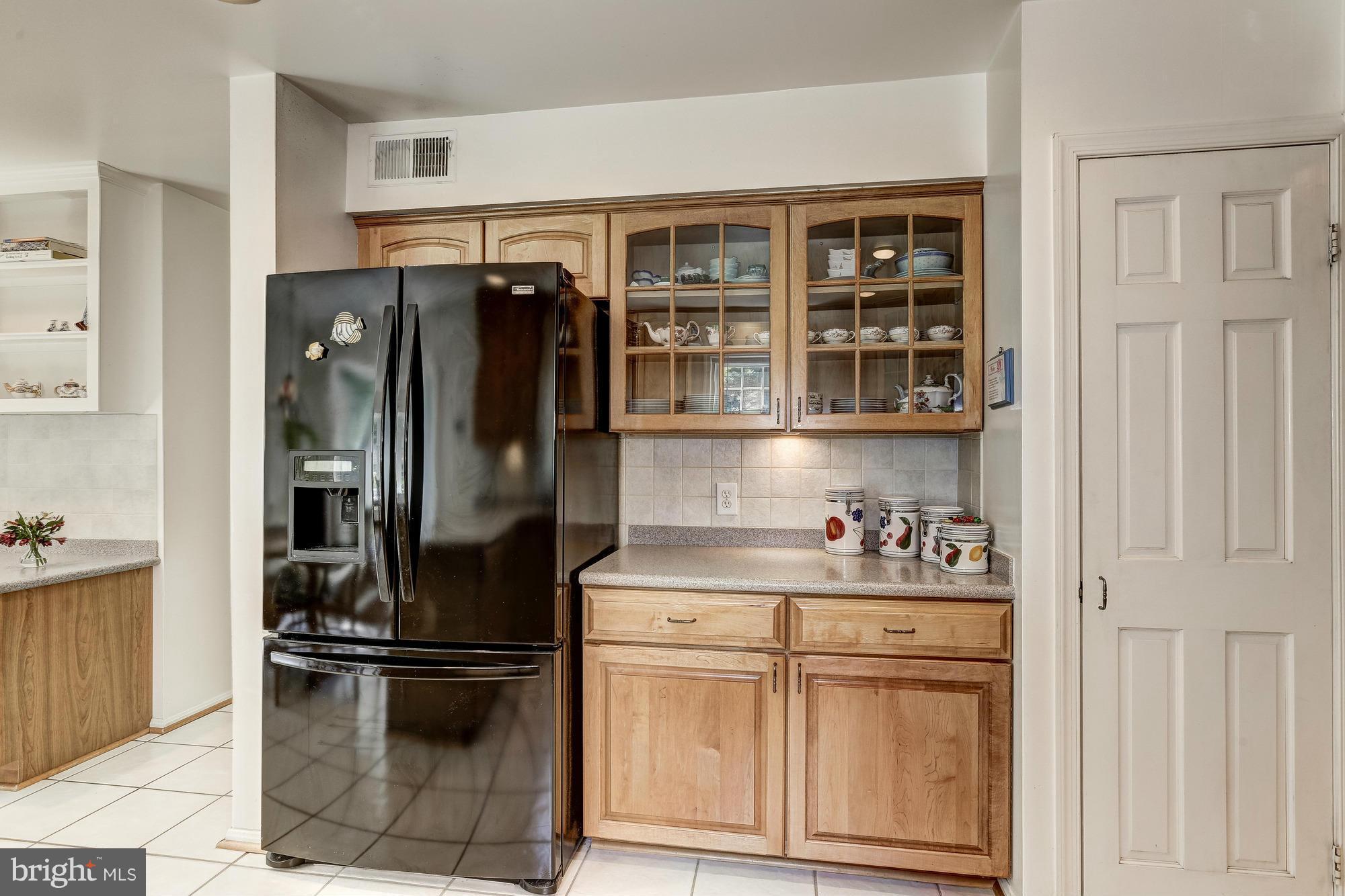 11819 Riders Lane Reston, VA 20191 - Photo 14 of 30 a kitchen with stainless steel appliances a refrigerator and cabinets