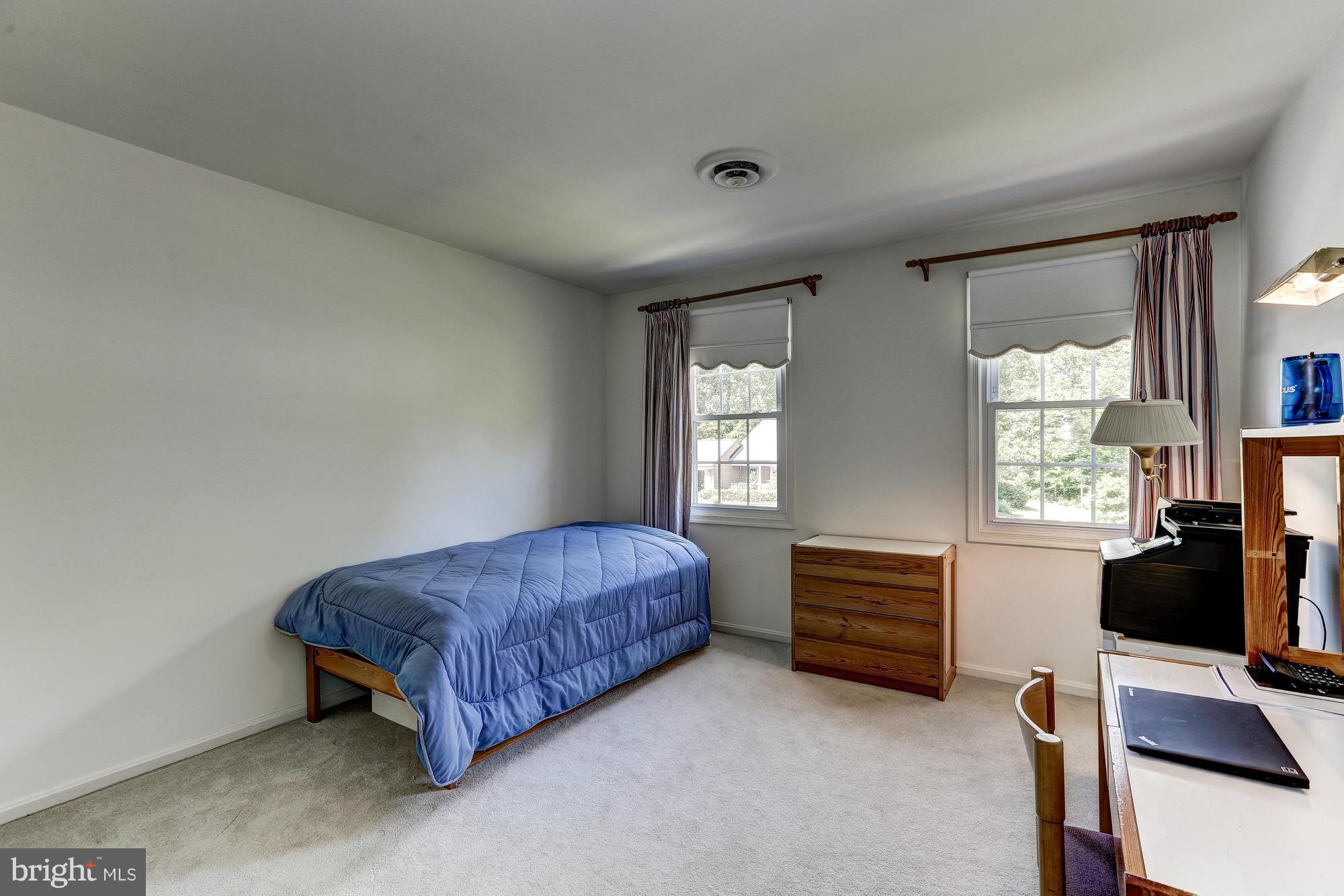 11819 Riders Lane Reston, VA 20191 - Photo 22 of 30 a bedroom with a bed and a window