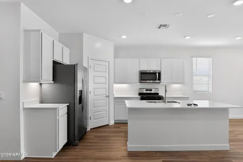 a kitchen with stainless steel appliances a refrigerator stove and microwave