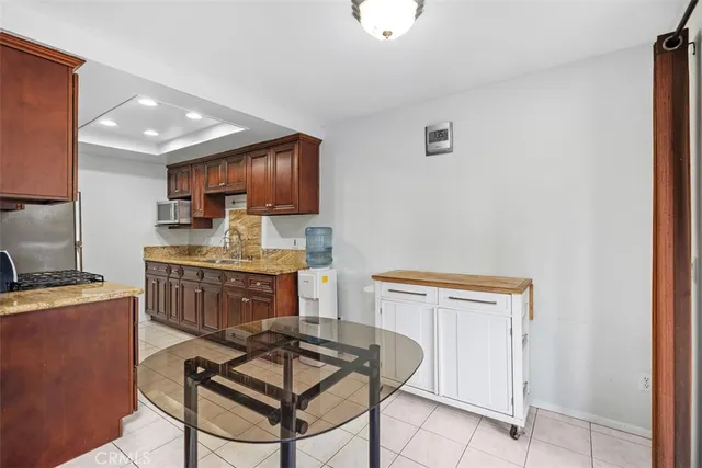 a kitchen with stainless steel appliances a stove a sink and a refrigerator