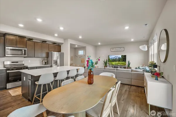 a kitchen with lots of counter top space and painting on the wall