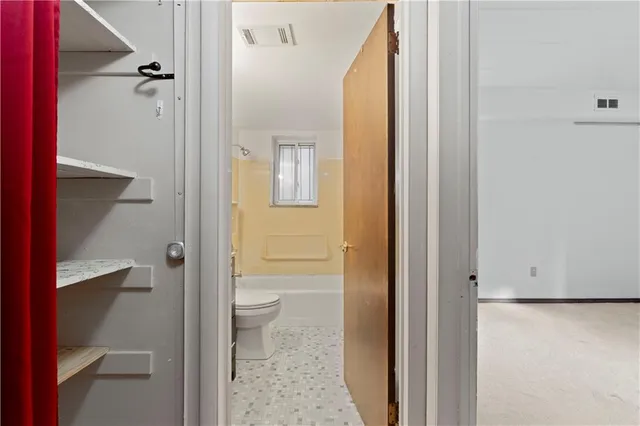 a bathroom with a granite countertop toilet