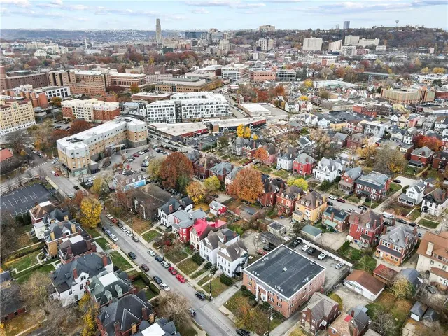 an aerial view of residential houses with outdoor space