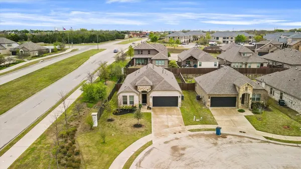 an aerial view of residential houses with outdoor space and ocean view