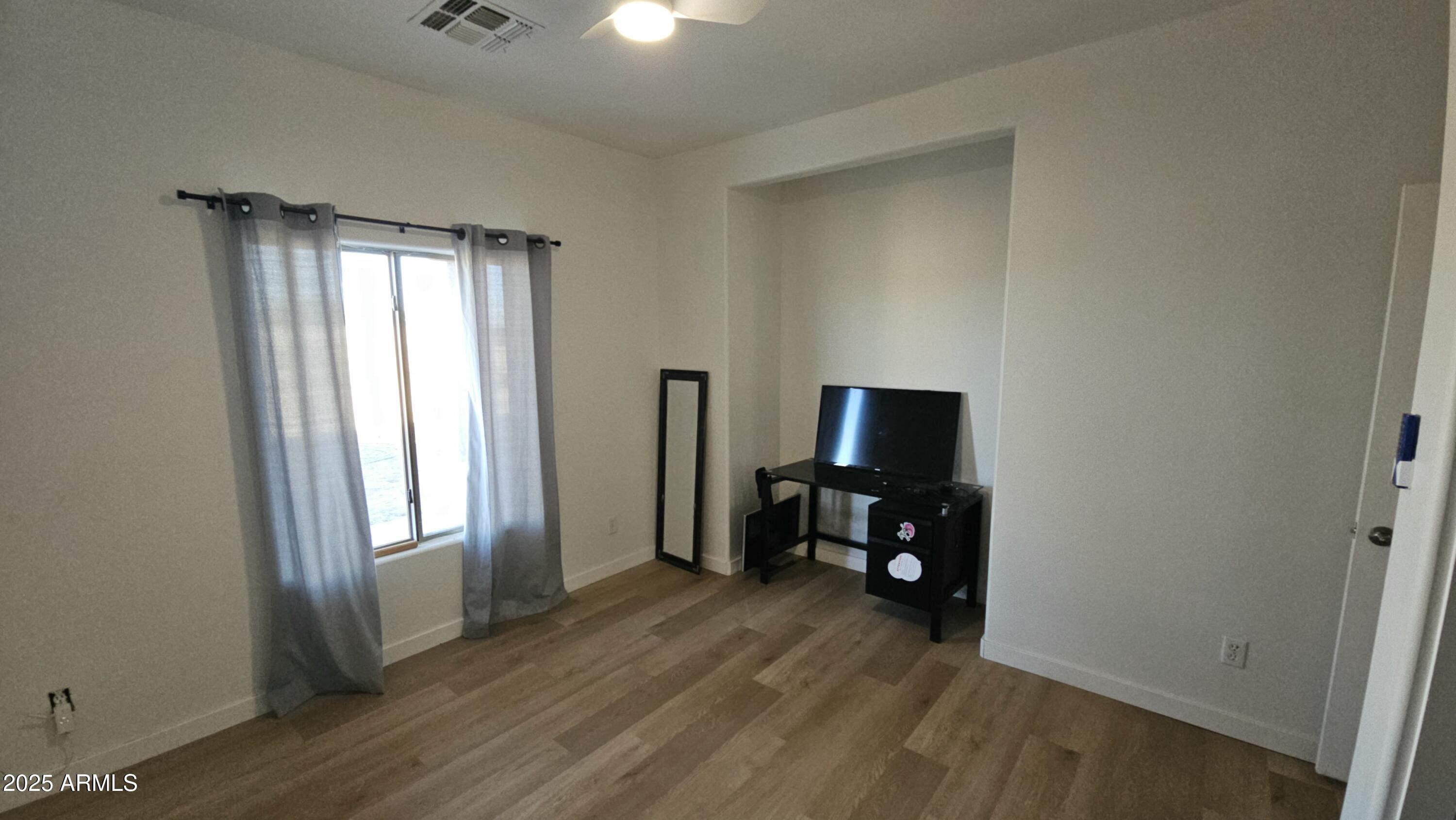 33340 West Lower Buckeye Road Tonopah, AZ 85354 - Photo 17 of 28 an empty room with mirror and a window