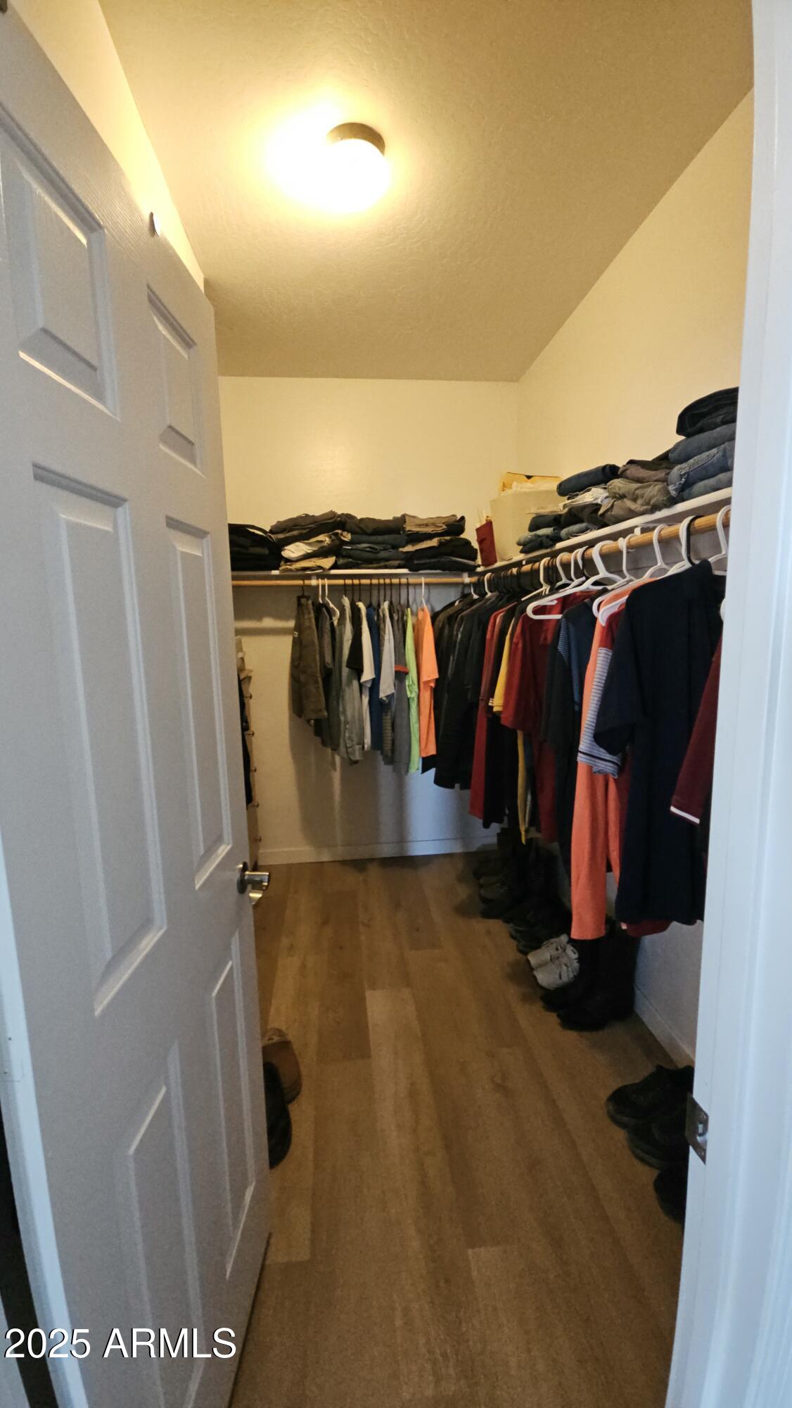 33340 West Lower Buckeye Road Tonopah, AZ 85354 - Photo 27 of 28 a view of walk in closet with clothes and shoes