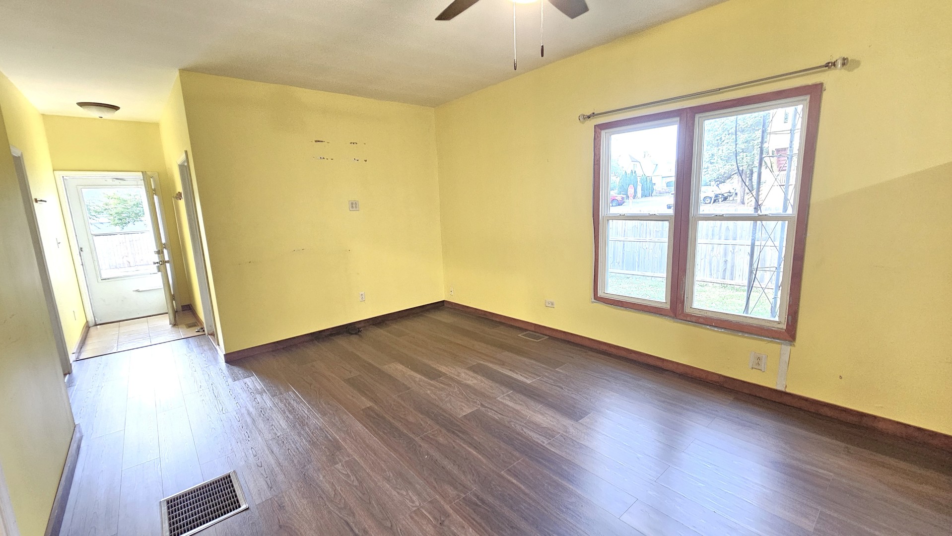 426 North Hebbard Street Joliet, IL 60432 - Photo 13 of 42 a view of an empty room with wooden floor and a window
