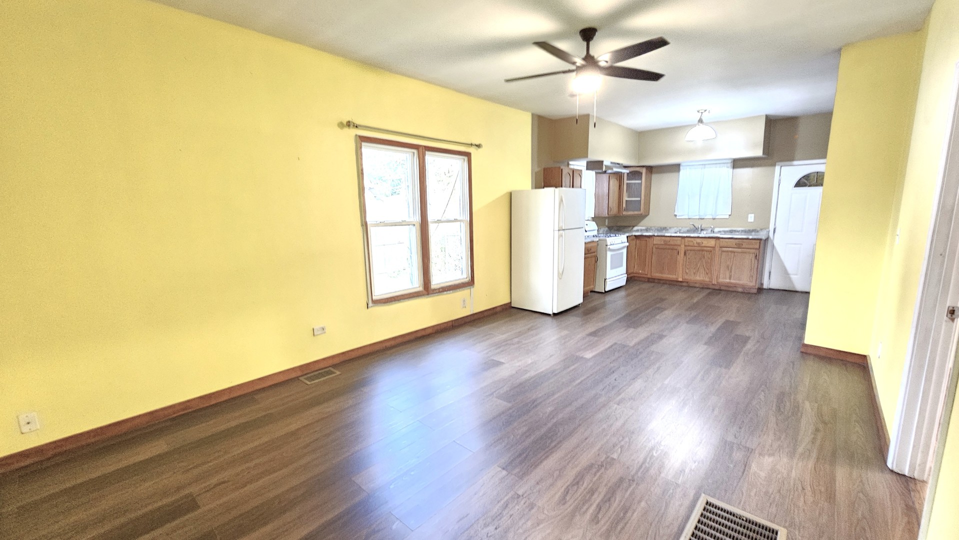 426 North Hebbard Street Joliet, IL 60432 - Photo 16 of 42 a view of a kitchen with wooden floor and a ceiling fan