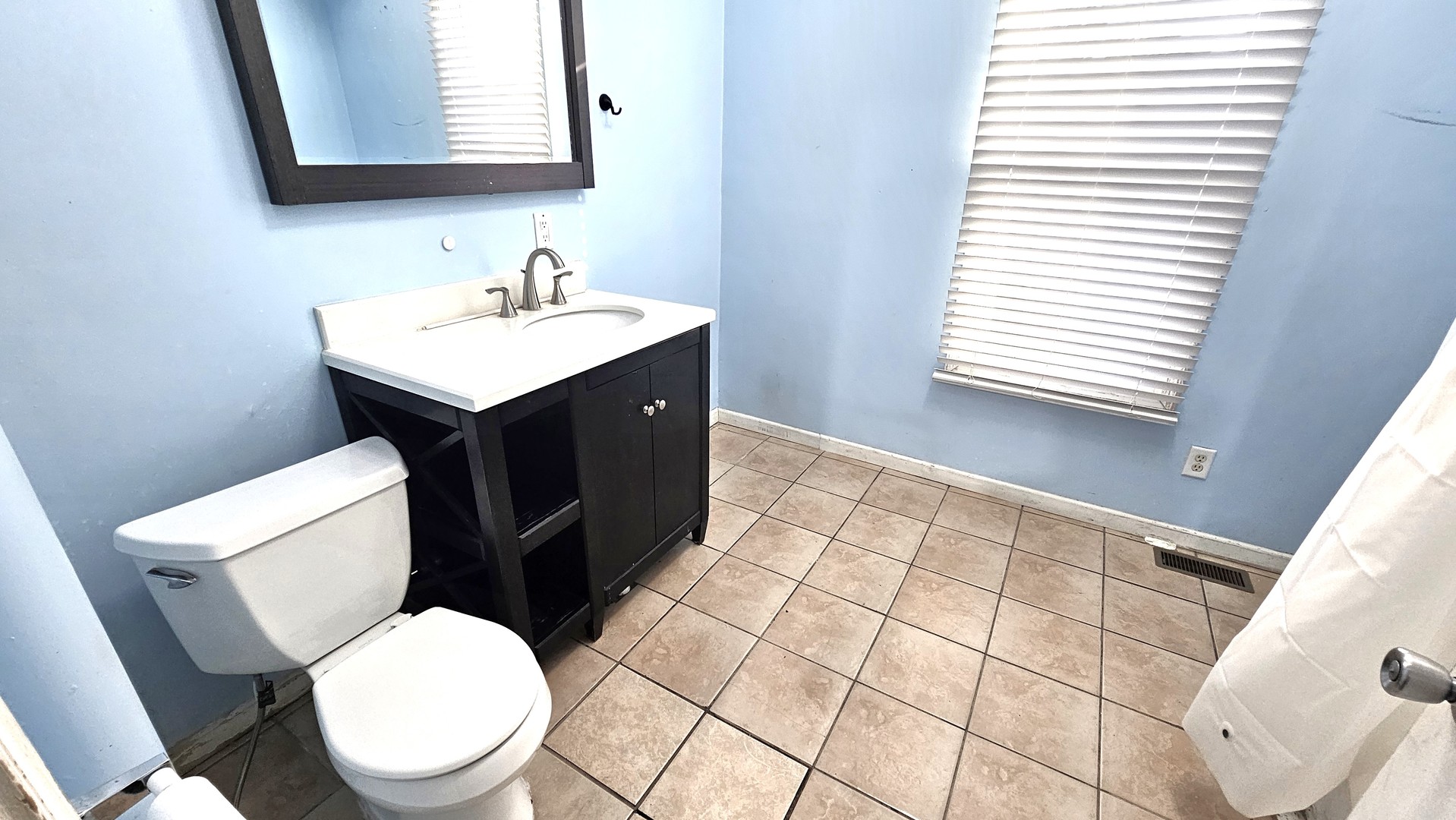 426 North Hebbard Street Joliet, IL 60432 - Photo 21 of 42 a bathroom with a sink a toilet and a mirror