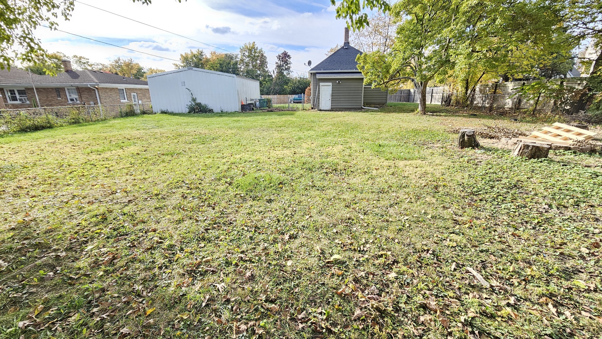 426 North Hebbard Street Joliet, IL 60432 - Photo 38 of 42 a front view of a house with a garden and trees