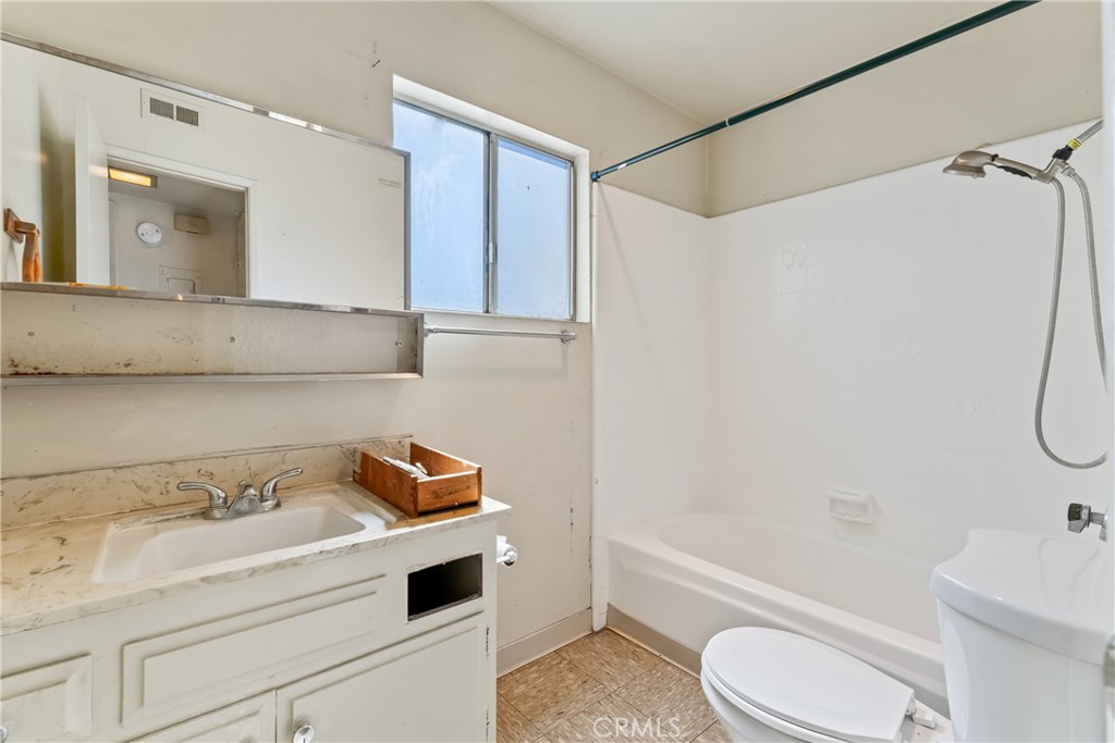 4641 Arlington Avenue Riverside, CA 92504 - Photo 12 of 33 a bathroom with a sink a toilet and a bathtub