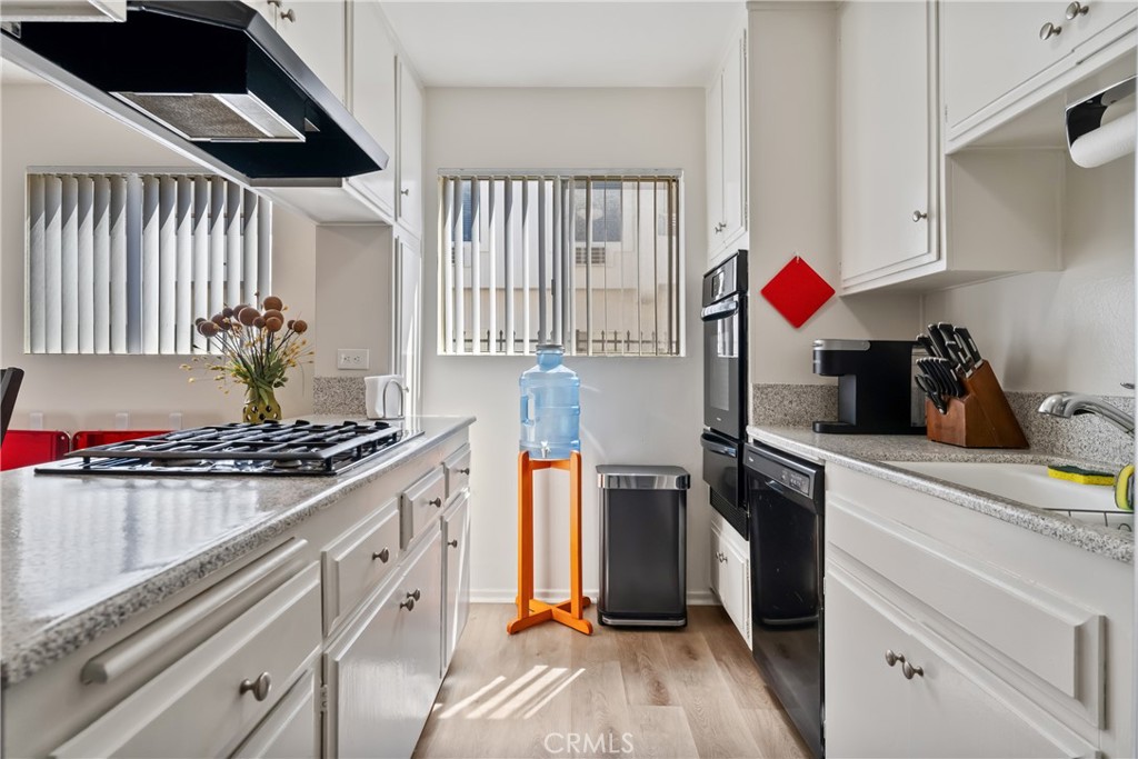 4641 Arlington Avenue Riverside, CA 92504 - Photo 17 of 33 a kitchen with stainless steel appliances granite countertop a stove and a refrigerator